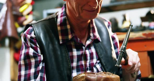 Shoemaker hammering on a shoe