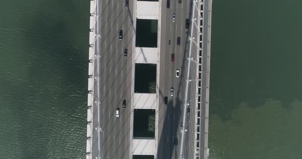 Aerial shot of vehicles moving on San Francisco–Oakland Bay Bridge with city in background