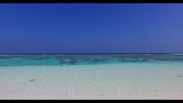 Aerial above sky of idyllic coast beach trip by blue green water and white sand background of a picn