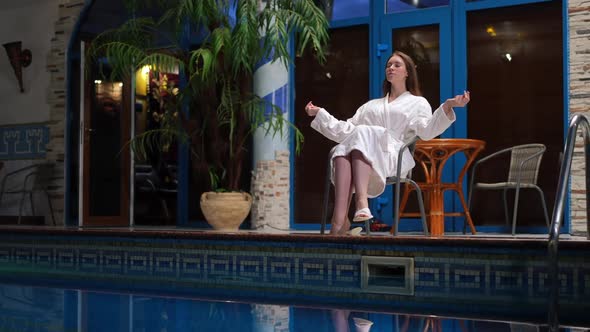 Wide Shot Confident Relaxed Young Woman Sitting with Closed Eyes at Pool Meditating