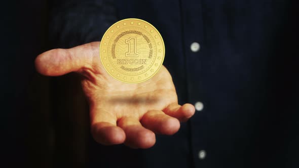 Bitcoin cryptocurrency golden 3d coin over hand