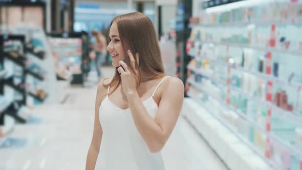 Caucasian Beautiful Young Woman Looking at the Shelves with Goods