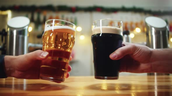 Toasting with Foamy Beer in Glasses Closeup