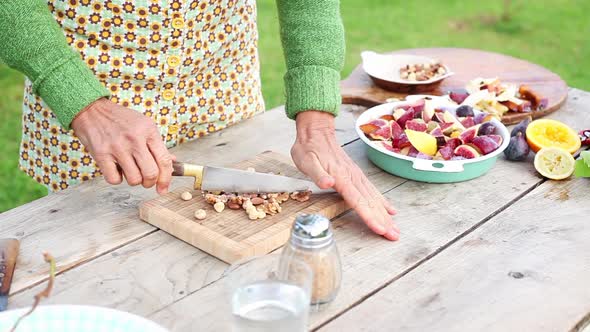 Woman chopping nuts outdoors