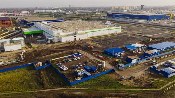 Machines Drive Along Construction Site of Shopping Mall