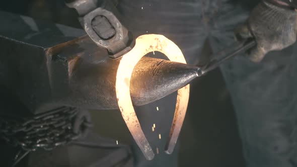 The Blacksmith Creates the Shape of a Hot Horseshoe.