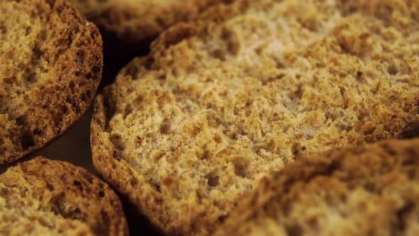 A bunch of baked rusks. Macro shot Rotating textured slices with crus