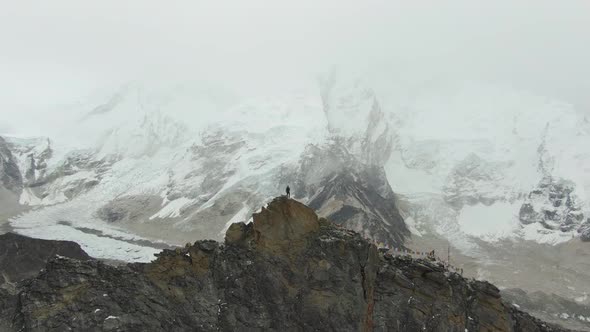 Man on Top of Kala Patthar Mountain. Everest and Nuptse. Nepal. Aerial View