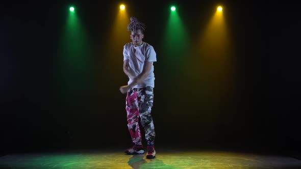 Professional Young Hip-hop Dancer, Dancing in Dark Studio in the Green and Yellow Fog, Hip Hop