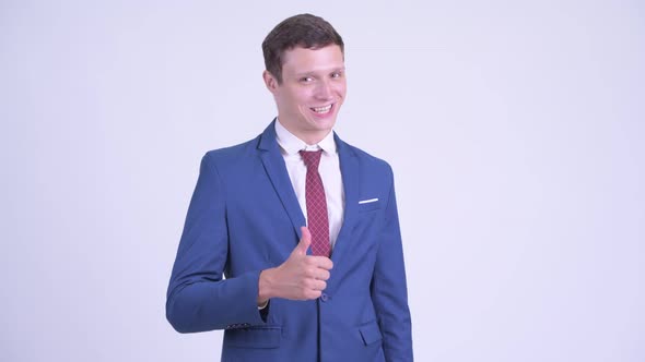 Happy Young Handsome Businessman Giving Thumbs Up