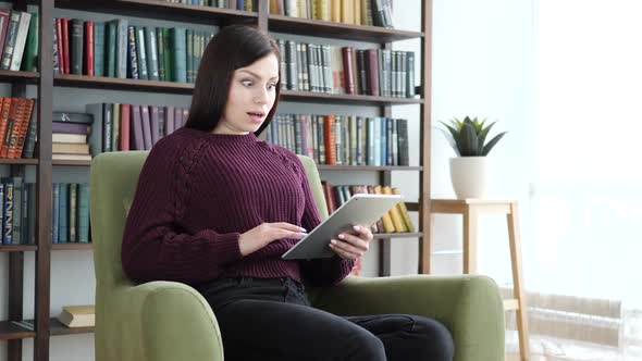 Shocked Stunned Woman Using Tablet for Browsing