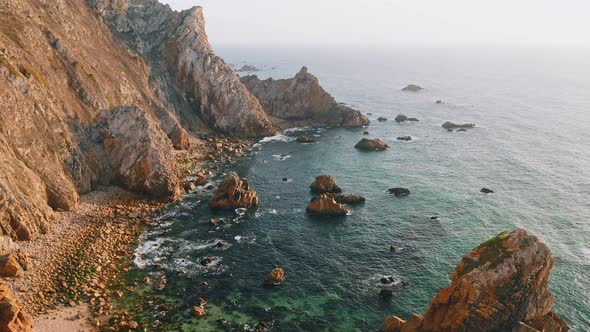 Aerial Drone View of Praia Da Ursa Beach in Sintra Portugal in Sunset Golden Hour Light