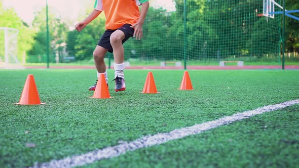 Boy Doing Running Exercises with Racks that Are Placed on One Line to Improve