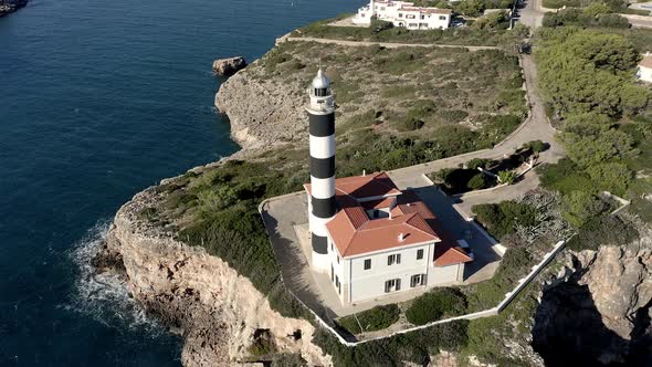 Portocolom lighthouse on cliff at the sea, Mallorca, Spain