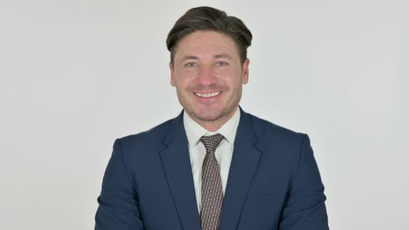 Middle Aged Businessman Smiling at Camera, White Background