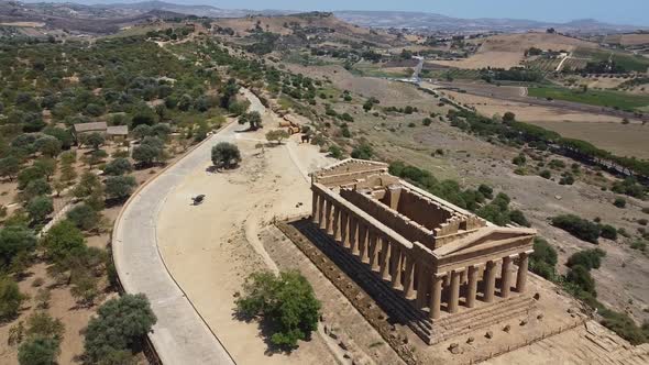 Aerial view of ancient greek temple and beautiful hill landscape in background,Sicily Italy