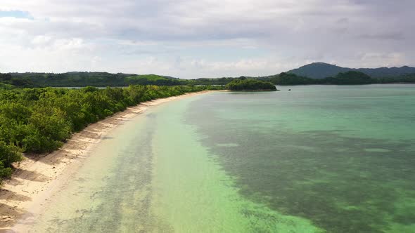 Tropical Island with a Turquoise Lagoon and White Sandy Beach, Top View.