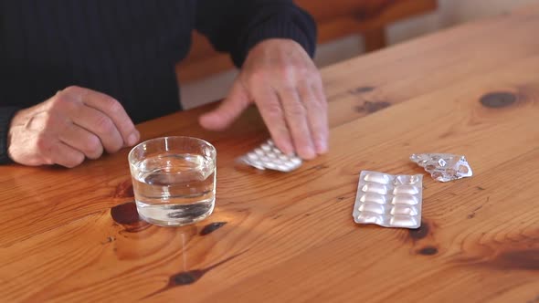 Senior Man Drink Pill with Water From Glass