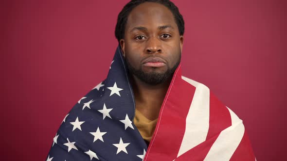 Confident African American Man Standing Covered with United States Flag