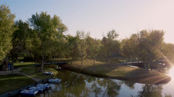 Apollo Park Lake with kayaks and boats at golden hour in Lancaster, California