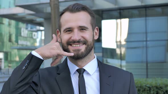 Call me for Help Gesture by Beard Businessman