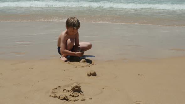 Little Boy Building Sand Castles on Sea Beach alt