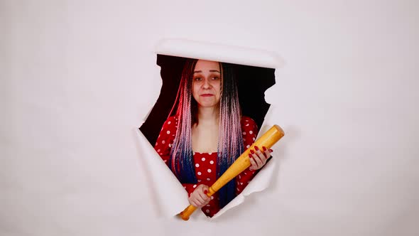 Young Woman with Baseball Bat in Hole of White Background