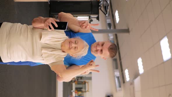 Portrait of a Young Coach in Uniform and an Old Woman in Gym