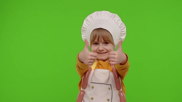 Child Girl Kid Dressed As Cook Chef Showing Thumbs Up Smiling Looking at Camera on Chroma Key