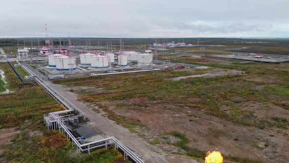 A Drone Takes Off Over a Torch From an Oil Producing Enterprise