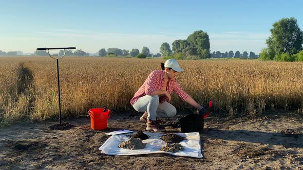 Woman Agronomy Specialist Preparing for Soil Testing with Soil Tester