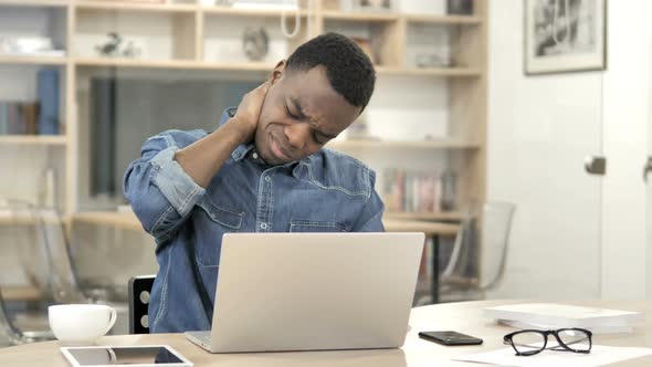 Afro-American Man with Neck Pain Working on Laptop