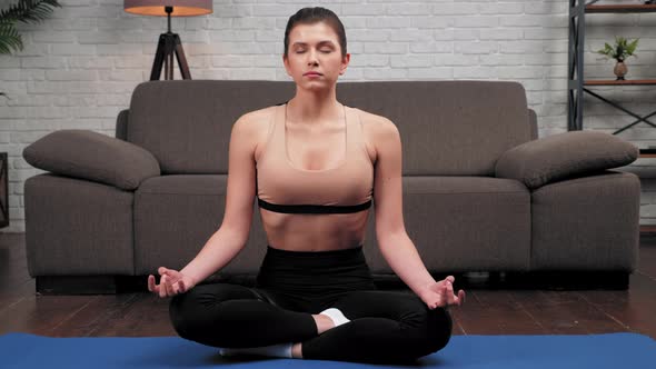 Close Up Calm Sportive Woman in Sportswear Practices Yoga at Home in Bedroom