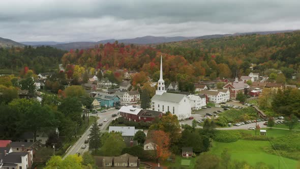 Church Building Small Town with Scenic Fall Foliage Forest Landscape Background