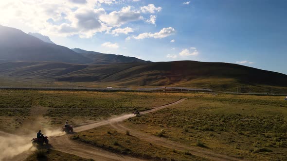 Aerial View From Behind ATVs by Lake and Mountain