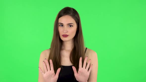 Woman Strictly Gesturing with Hands Shape Meaning Denial Saying NO. Green Screen