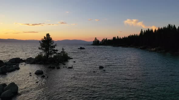 Flying Over Scenic Lake Tahoe At Sunset In California, USA - aerial drone shot