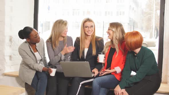 Group of Multiracial Businesswomen in Casual Wear Looking at the Laptop Together