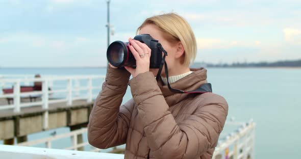 Beautiful Young Woman Fogographer Photographs the Landscape