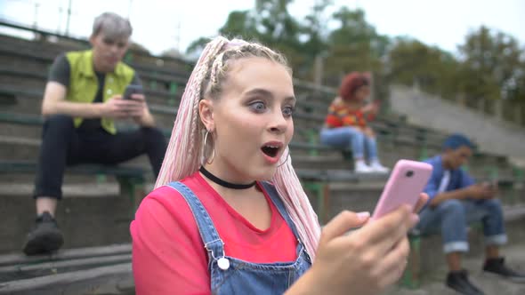 Excited Pretty Teenager Reading Smartphone Message Sitting Stadium Stairs, News