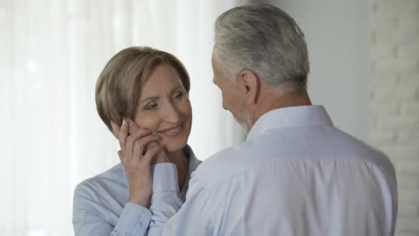 Aged Male Cupping Woman Cheek Putting His Forehead Against Hers, Loving Feelings