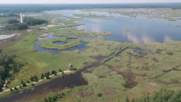 Jurmala, Latvia - Drone aerial flight bird view of Birdwatching Tower of Riekstusala at Kaniera Lake