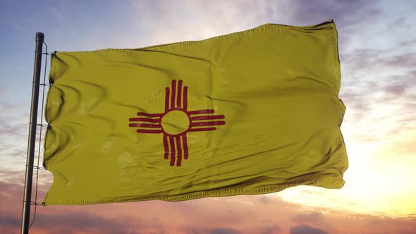 Flag of New Mexico Waving in the Wind Against Deep Beautiful Sky at Sunset