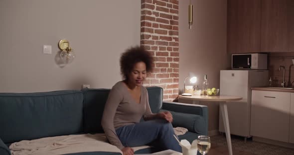 African American Woman Using Laptop During Dinner