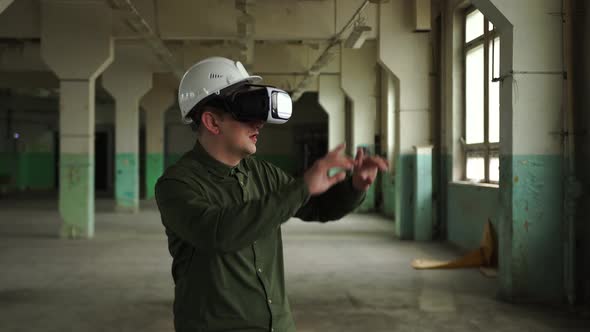 An Engineer Wearing Virtual Reality Glasses Moves Digital Objects with His Hands