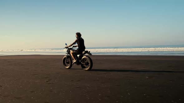 Man on a Sportbike Driving By an Ocean Shore