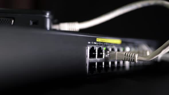 Network switch with Ethernet utp cables panning shot