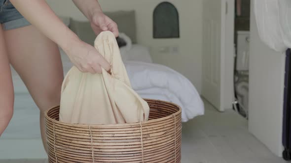 Housewife Takes a Bag of Dirty Laundry to the Bathroom