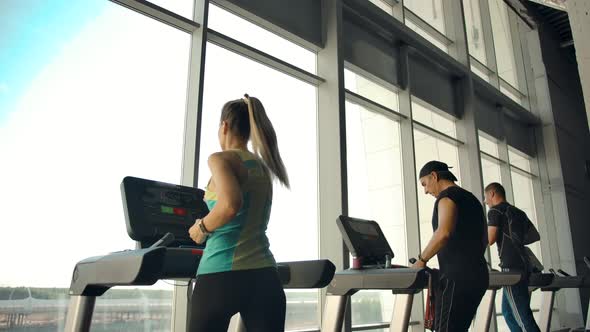 Athletes in the Gym is Engaged on Treadmills