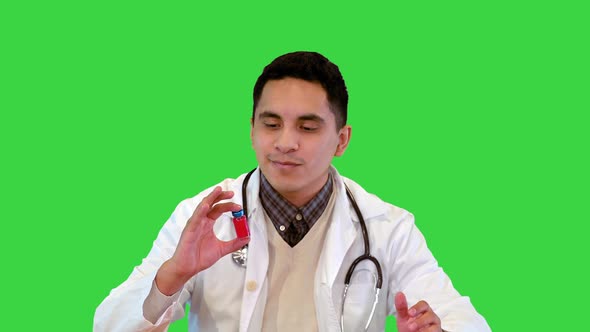 Positive Doctor Holding an Ampoule with Vaccine Talking on Camera on a Green Screen Chroma Key